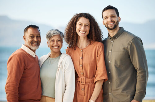 Portrait, couple and senior parents at beach on holiday, vacation or travel. Face, family men and w.